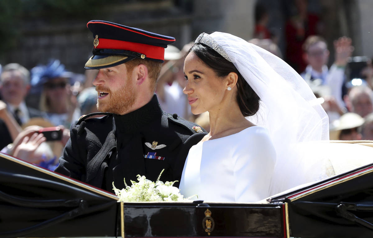 Britain's Prince Harry and his wife Meghan Markle leave after their wedding ceremony, at St. Ge ...