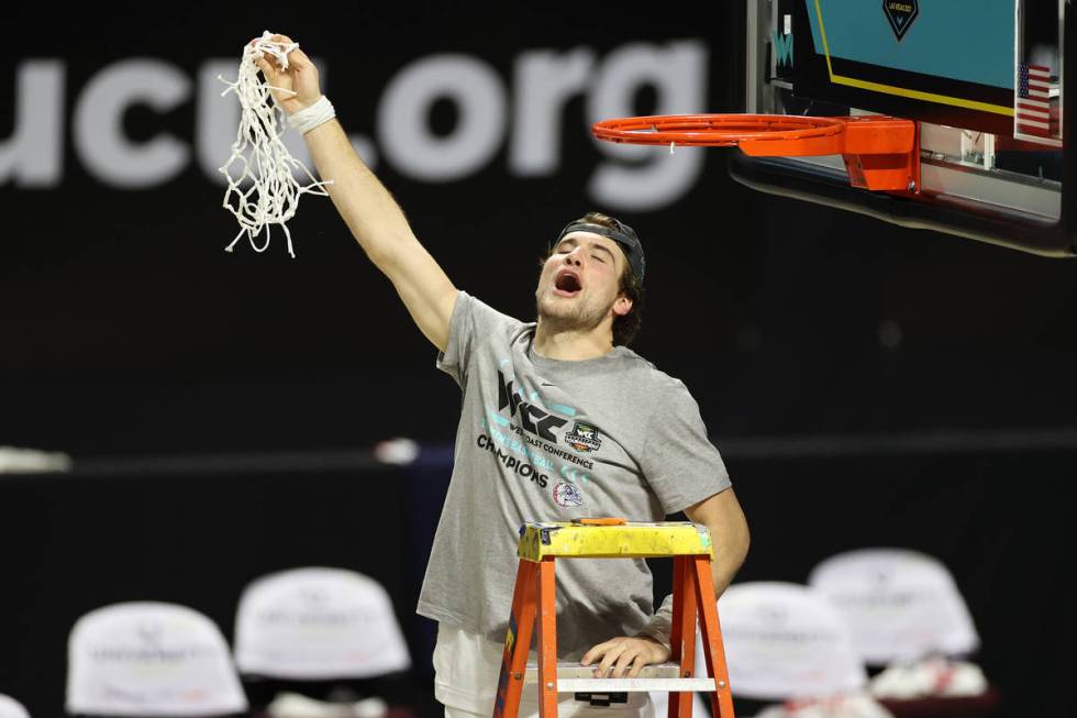 Gonzaga Bulldogs forward Corey Kispert (24) removes the net from the basket in celebration of h ...