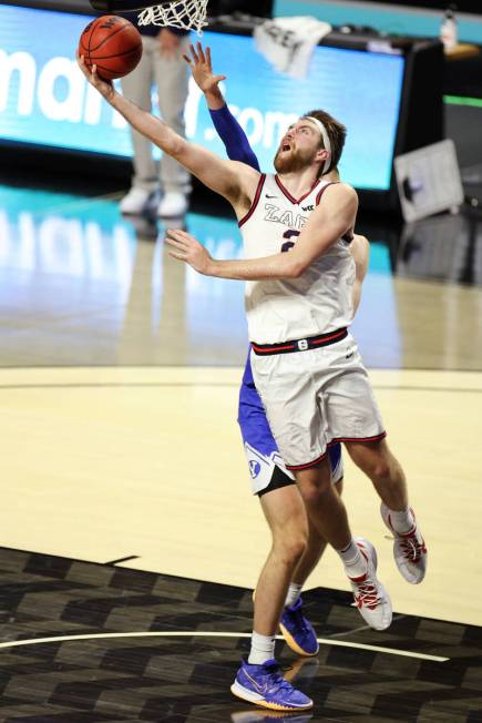 Gonzaga Bulldogs forward Drew Timme (2) goes up for a shot under pressure from Brigham Young Co ...