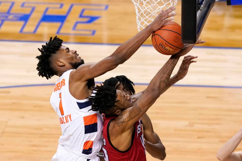 Syracuse forward Quincy Guerrier (1) battles North Carolina State forward Manny Bates, right, f ...