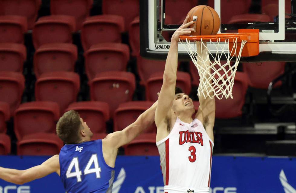 UNLV guard Caleb Grill (3) dunks as Air Force forward Keaton Van Soelen (44) defends during the ...