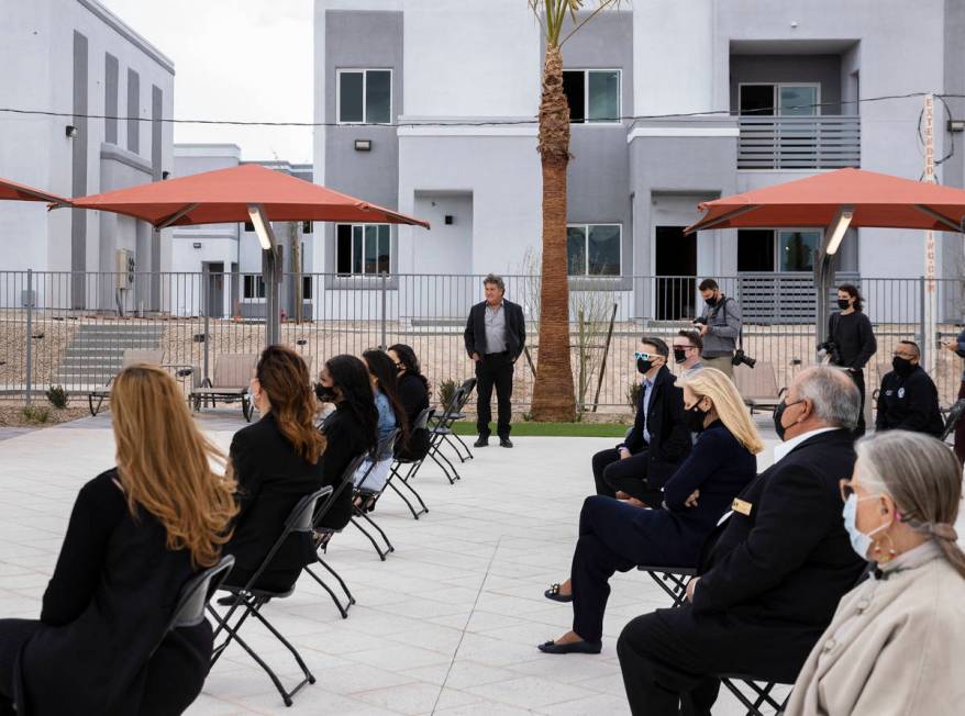 Attendees and Chi Chi Bengochea, center standing, developer of the Showboat Park apartment comp ...