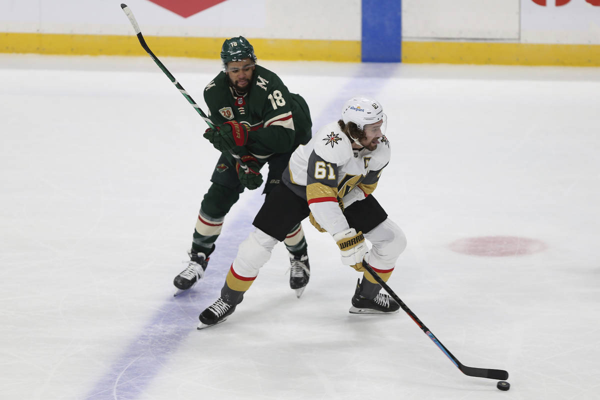 Vegas Golden Knights' Mark Stone (61) gains control of the puck against Minnesota Wild's Jordan ...