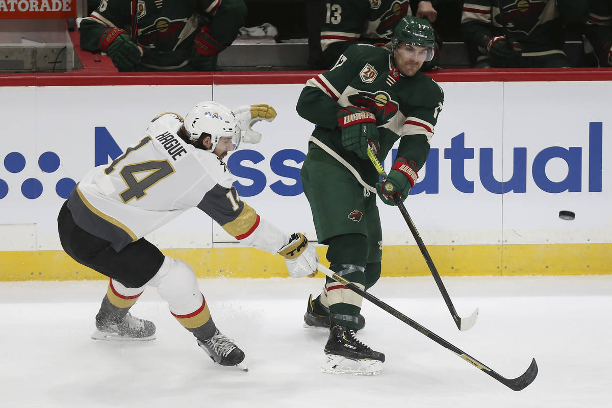 Minnesota Wild's Marcus Foligno (17) passes the puck as Vegas Golden Knights' Nicolas Hague (14 ...