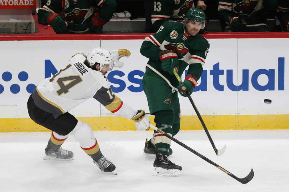 Minnesota Wild's Marcus Foligno (17) passes the puck as Vegas Golden Knights' Nicolas Hague (14 ...