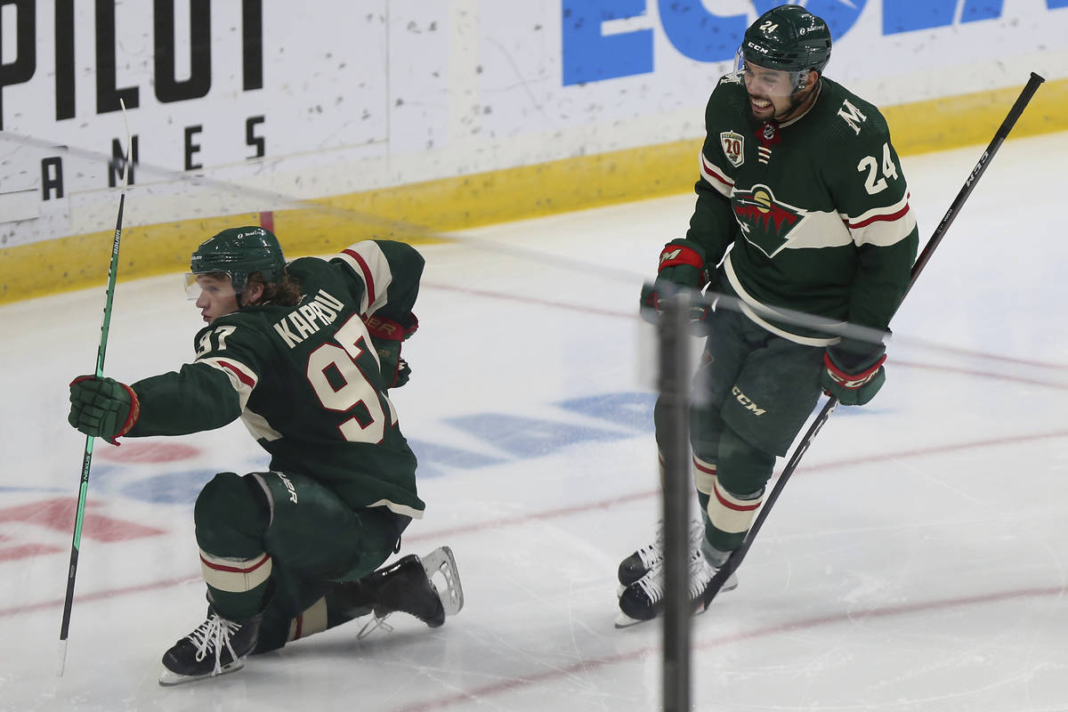 Minnesota Wild's Kirill Kaprizov (97) celebrates on the ice with Matt Dumba (24) after scoring ...