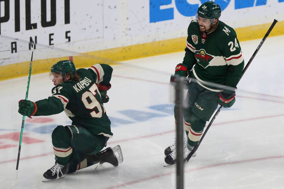 Minnesota Wild's Kirill Kaprizov (97) celebrates on the ice with Matt Dumba (24) after scoring ...