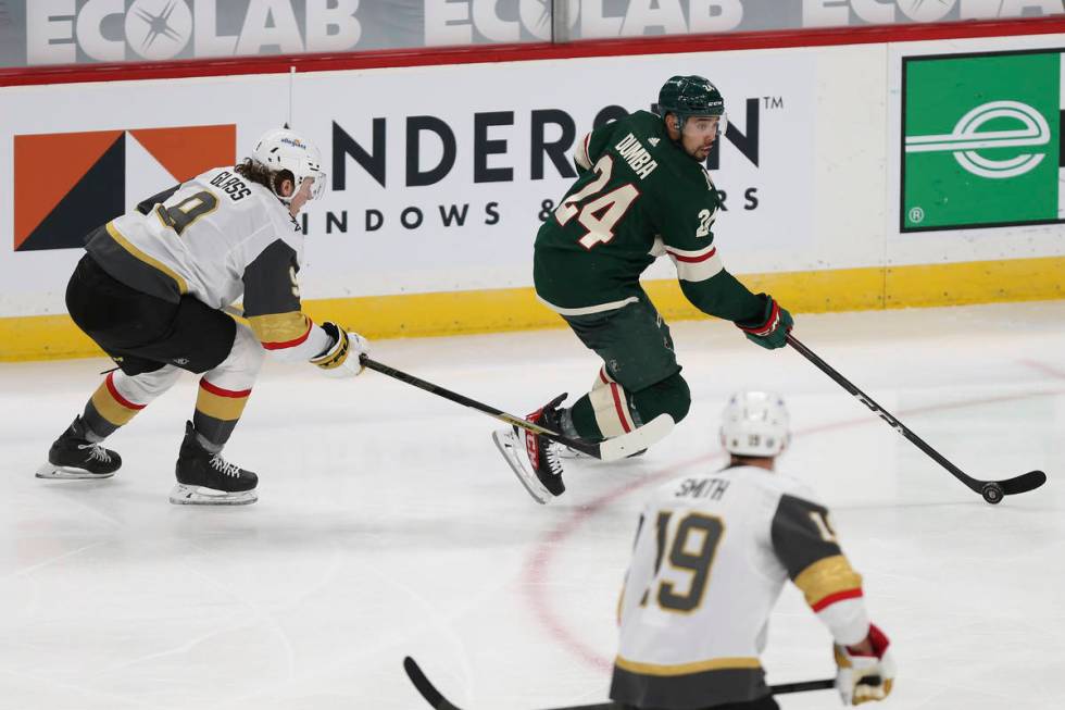 Minnesota Wild's Matt Dumba (24) controls the puck against Vegas Golden Knights' Cody Glass, le ...