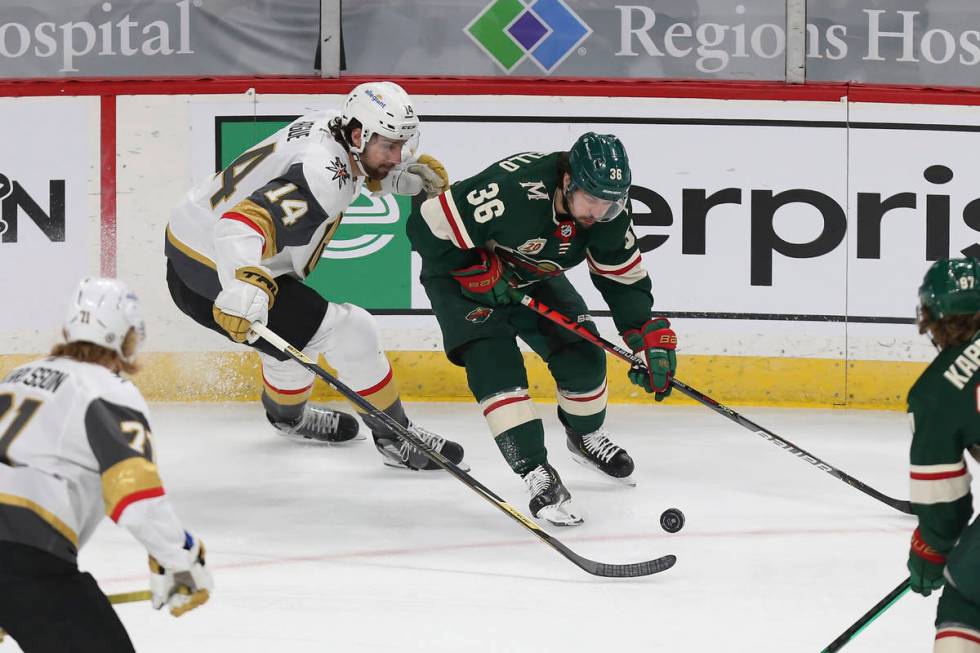 Minnesota Wild's Mats Zuccarello (36) and Vegas Golden Knights' Nicolas Hague (14) vie for the ...