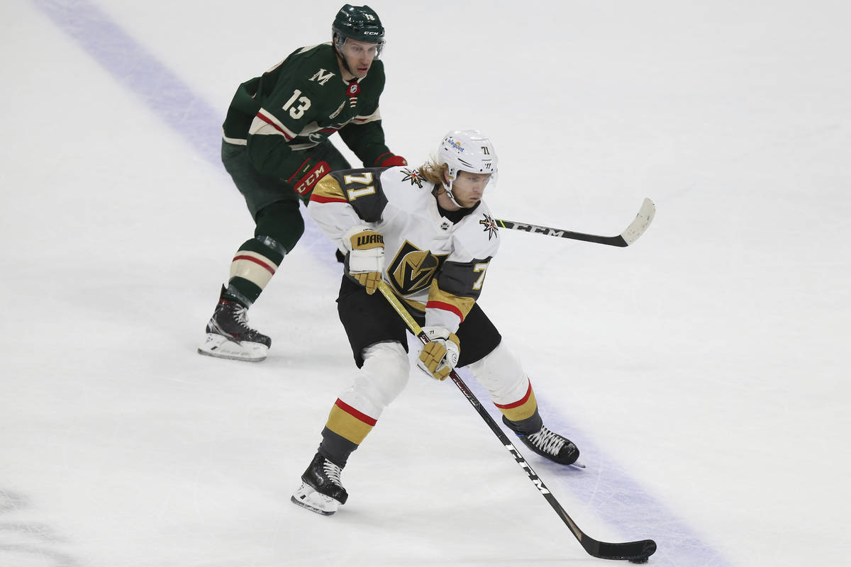 Vegas Golden Knights' William Karlsson (71) controls the puck next to Minnesota Wild's Nick Bon ...