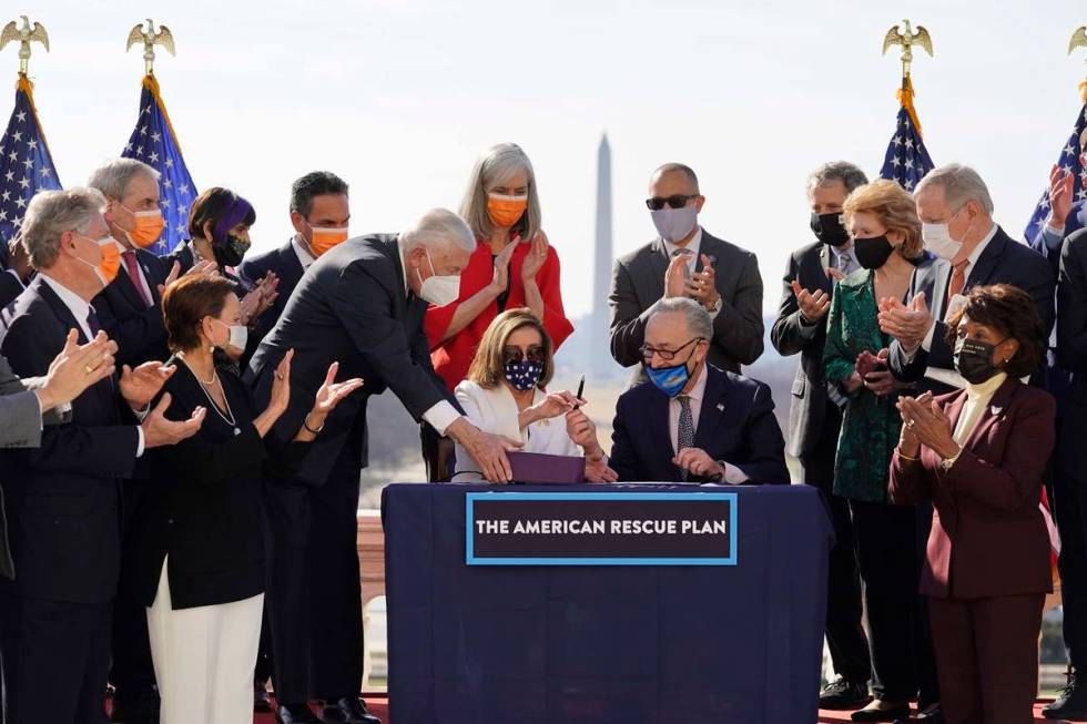 House Speaker Nancy Pelosi of Calif., and Senate Majority Leader Chuck Schumer of N.Y., sign th ...