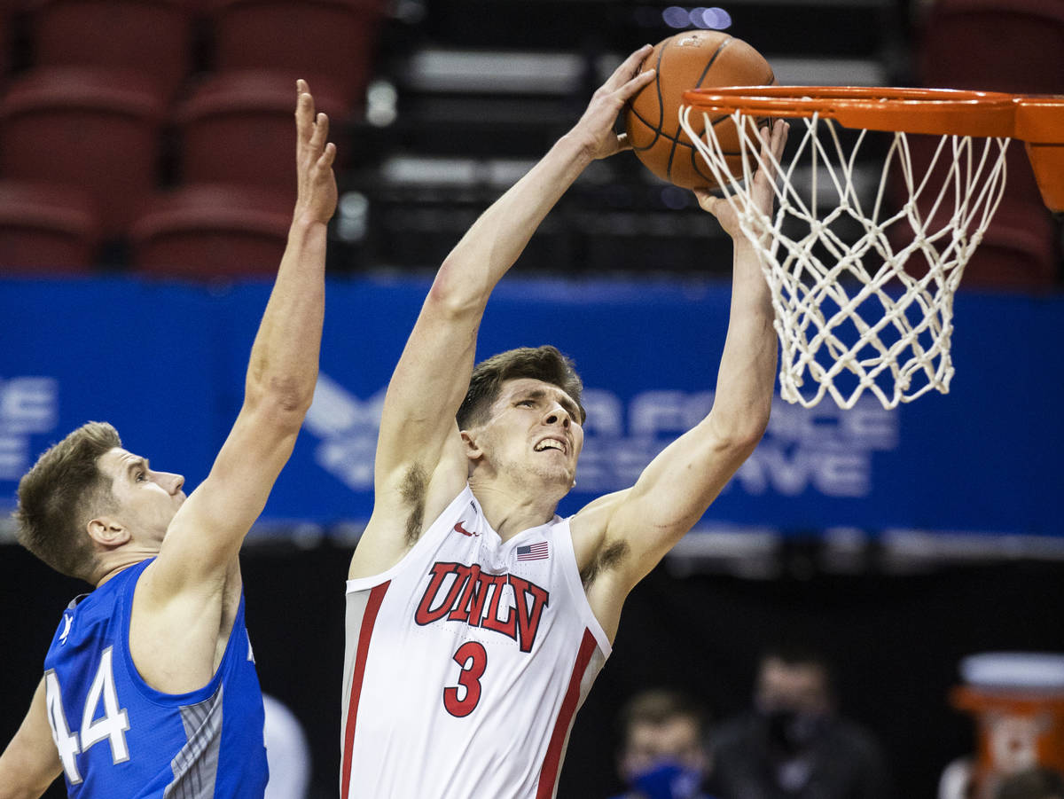 UNLV Rebels guard Caleb Grill (3) dunks over Air Force Falcons forward Keaton Van Soelen (44) i ...