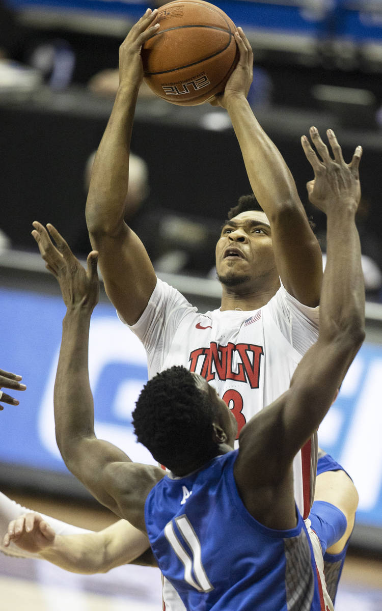 UNLV Rebels guard Bryce Hamilton (13) shoots over Air Force Falcons guard Ameka Akaya (11) in t ...