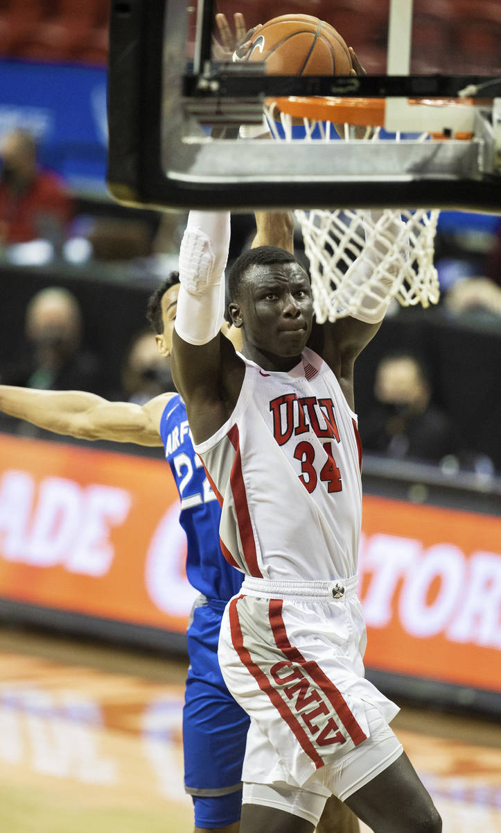 UNLV Rebels forward Cheikh Mbacke Diong (34) dunks over Air Force Falcons forward Nikc Jackson ...