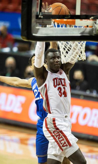 UNLV Rebels forward Cheikh Mbacke Diong (34) dunks over Air Force Falcons forward Nikc Jackson ...