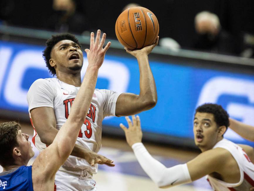 UNLV Rebels guard Bryce Hamilton (13) slices to the rim past Air Force Falcons guard Carter Mur ...