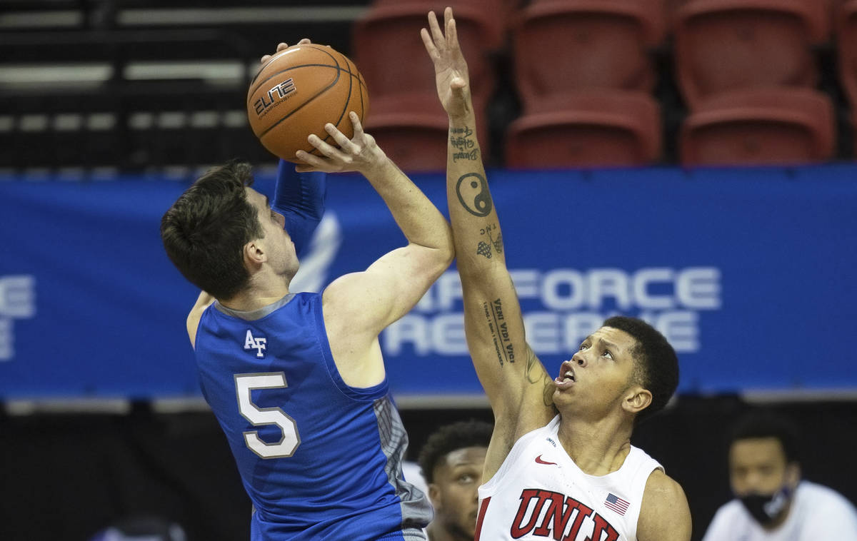 UNLV Rebels guard Nicquel Blake (22) contests the shot of Air Force Falcons guard Chris Joyce ( ...