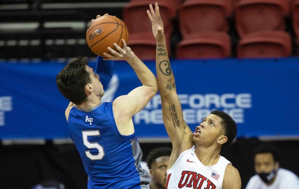 UNLV Rebels guard Nicquel Blake (22) contests the shot of Air Force Falcons guard Chris Joyce ( ...