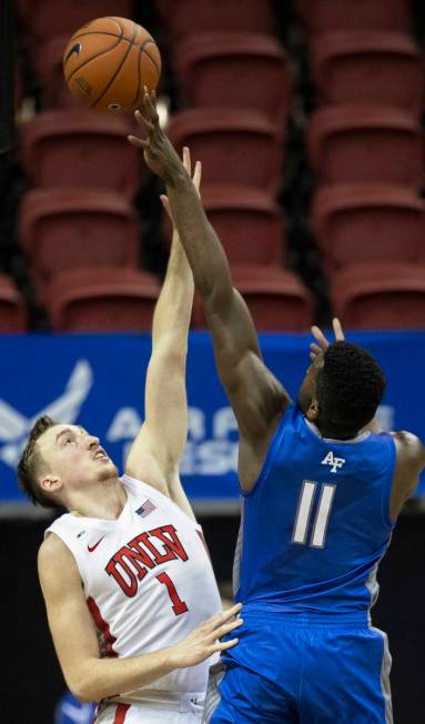 UNLV Rebels forward Moses Wood (1) contests the shot of Air Force Falcons guard Ameka Akaya (11 ...