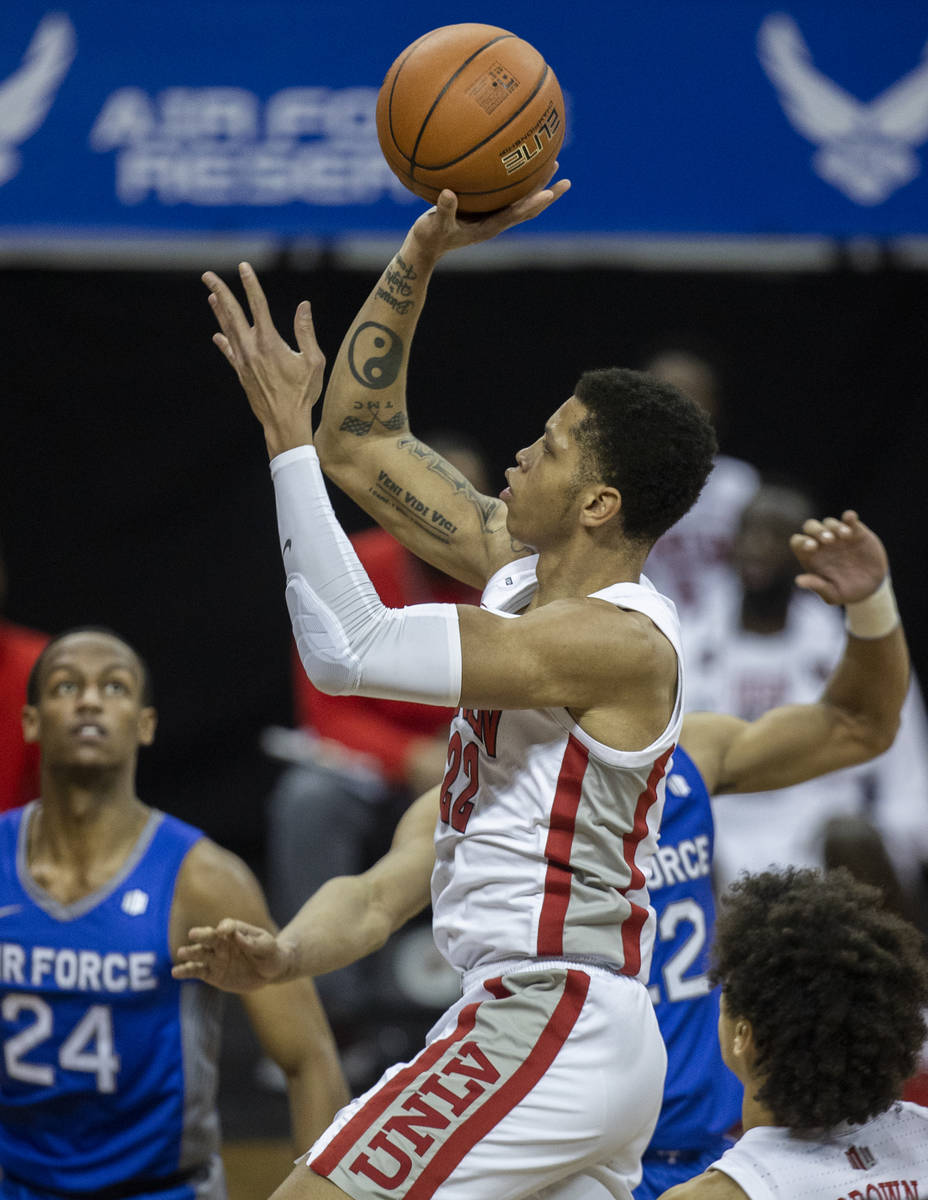 UNLV Rebels guard Nicquel Blake (22) drives past Air Force Falcons guard Mason Taylor (24) in t ...