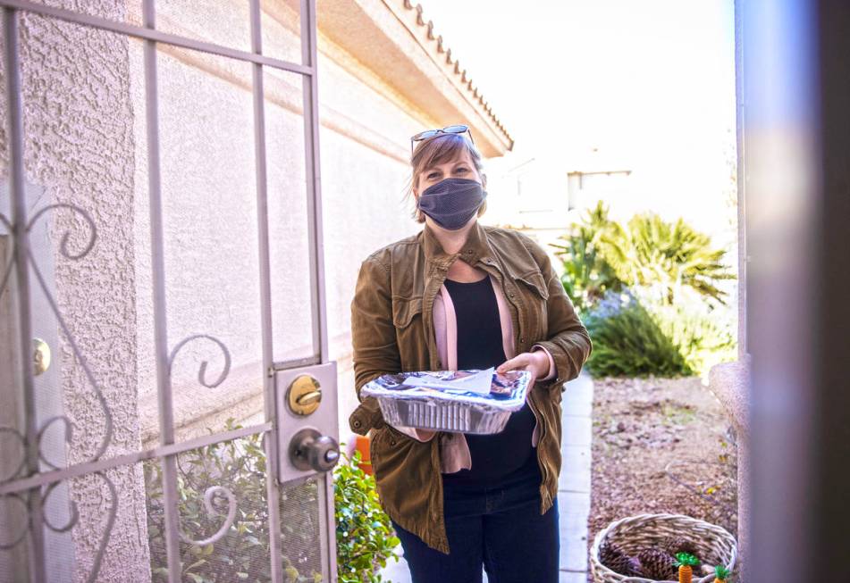 Amy Kelly delivers lasagne to a home in Las Vegas as part of the Lasagne Love program on Feb. 2 ...