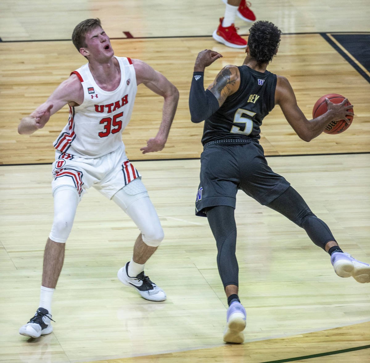 Utah Utes center Branden Carlson (35) reacts to a shot to the face as Washington Huskies guard ...