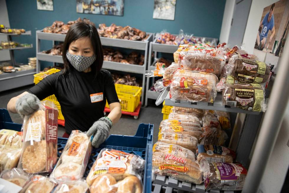 Volunteer Loan Ha organizes bread at the City Impact Urban Food Bank in Las Vegas, on Wednesday ...