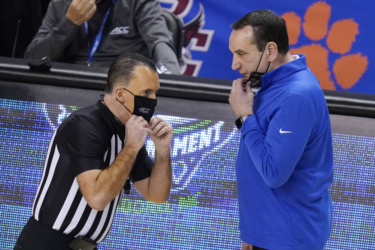 Duke head coach Mike Krzyzewski, right, talks with a ref during the second half of an NCAA coll ...