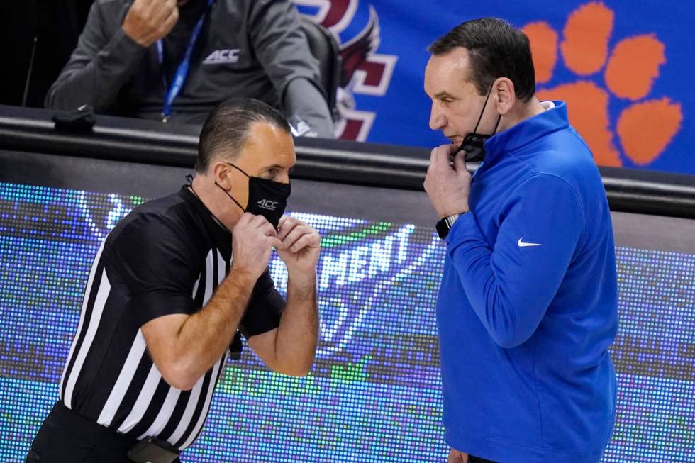 Duke head coach Mike Krzyzewski, right, talks with a ref during the second half of an NCAA coll ...