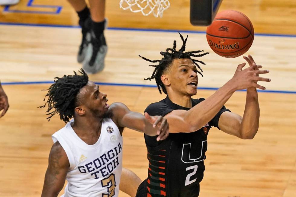 Miami guard Isaiah Wong (2) battles for a rebound with Georgia Tech guard Bubba Parham (3) duri ...