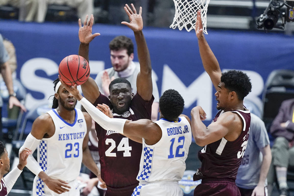 Kentucky's Keion Brooks Jr. (12) shoots against Mississippi State's Abdul Ado (24) and Tolu Smi ...