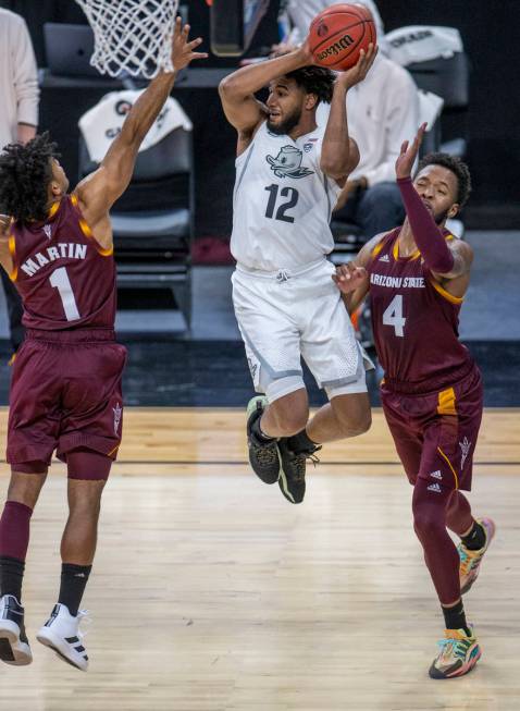 Oregon Ducks guard LJ Figueroa (12) catches some air to beat Arizona State Sun Devils guard Rem ...