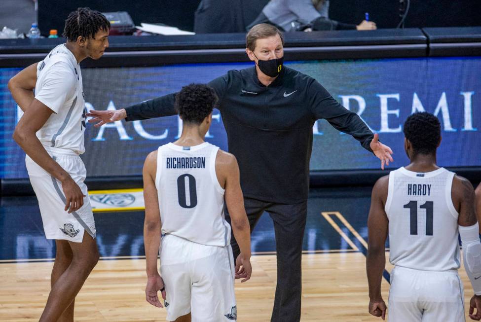 (Clockwise from top) Oregon Ducks head coach Dana Altman instructs Oregon Ducks guard Amauri Ha ...