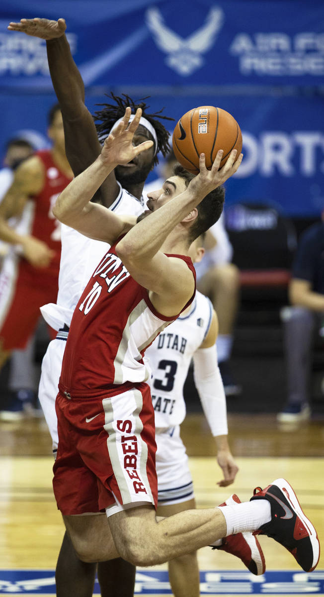 UNLV Rebels forward Edoardo Del Cadia (10) drives past Utah State Aggies center Neemias Queta ( ...