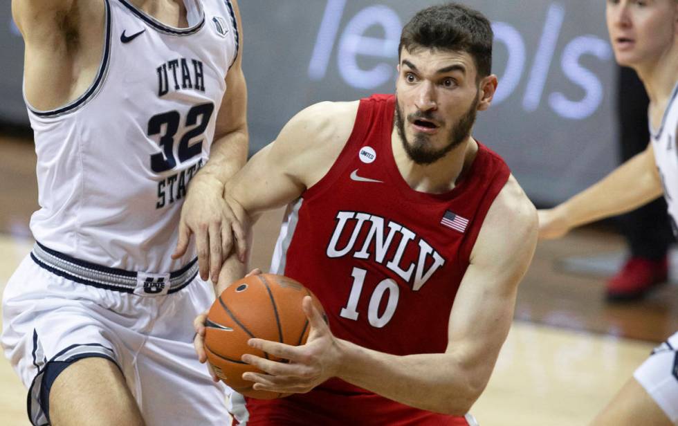 UNLV Rebels forward Edoardo Del Cadia (10) drives past Utah State Aggies center Trevin Dorius ( ...