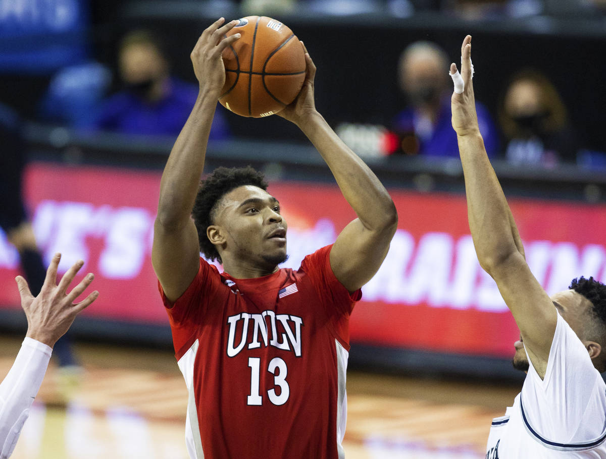 UNLV Rebels guard Bryce Hamilton (13) shoots over Utah State Aggies guard Marco Anthony (44) in ...