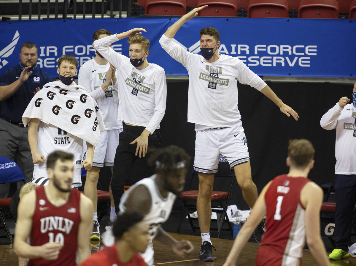 Utah State Aggies players celebrate a big play in the second half during the Mountain West conf ...