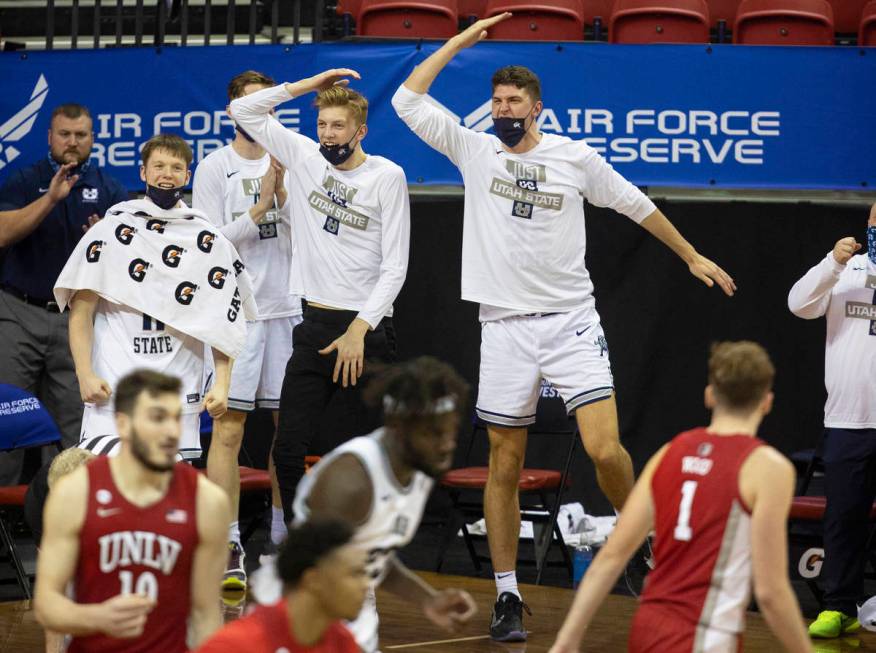 Utah State Aggies players celebrate a big play in the second half during the Mountain West conf ...