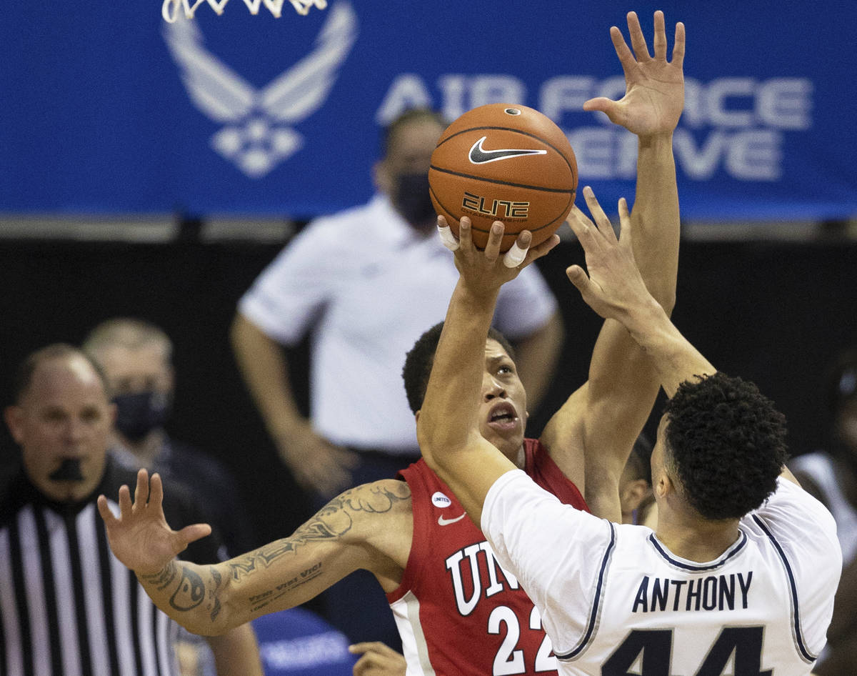 Utah State Aggies guard Marco Anthony (44) shoots over UNLV Rebels guard Nicquel Blake (22) in ...