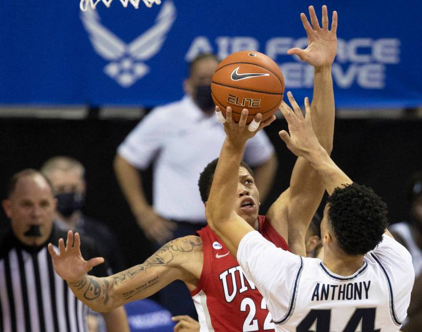 Utah State Aggies guard Marco Anthony (44) shoots over UNLV Rebels guard Nicquel Blake (22) in ...