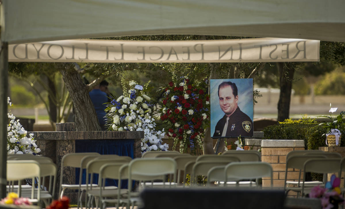 A portrait awaits mourners before a burial service for Las Vegas police Lt. Erik Lloyd on Aug. ...