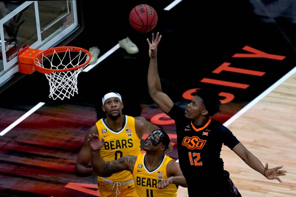 Oklahoma State's Matthew-Alexander Moncrieffe (12) shoots over Baylor's Mark Vital (11) and Flo ...