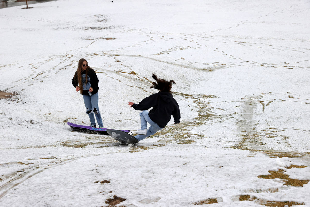 Phoebe Lee, 14, left, and Giselle Ornelas-Emerick, 13, both of Las Vegas, play in the snow at F ...