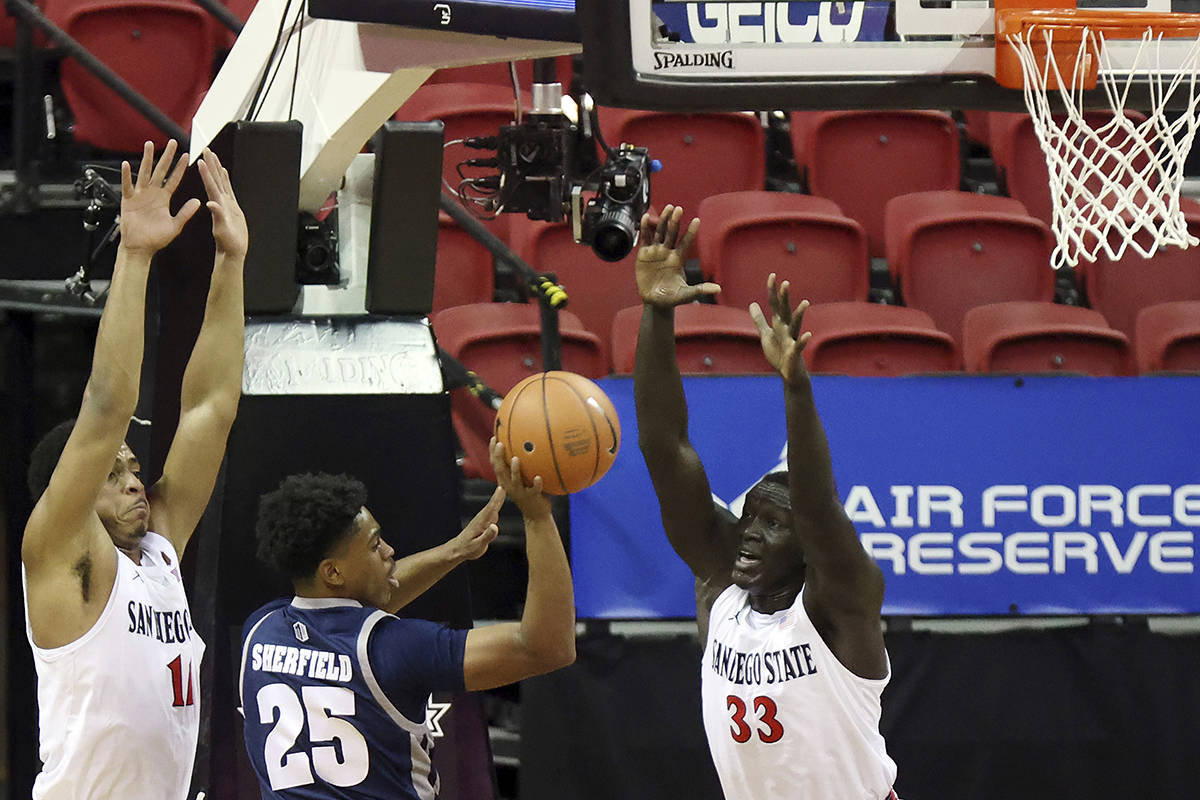 Nevada guard Grant Sherfield (25) passes as San Diego State forward Matt Mitchell (11) and forw ...