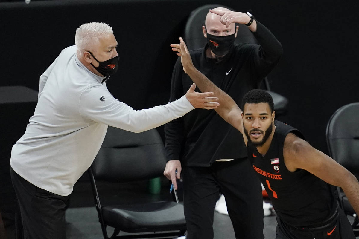 Oregon State head coach Wayne Tinkle celebrates after Maurice Calloo, right, scored a 3-point s ...