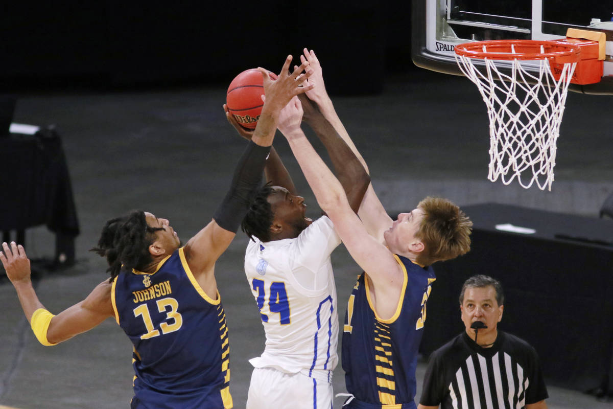 UC Santa Barbara's Robinson Idehen (24) is fouled as UC Irvine's Dean Keeler (31) and Austin Jo ...