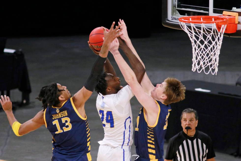 UC Santa Barbara's Robinson Idehen (24) is fouled as UC Irvine's Dean Keeler (31) and Austin Jo ...