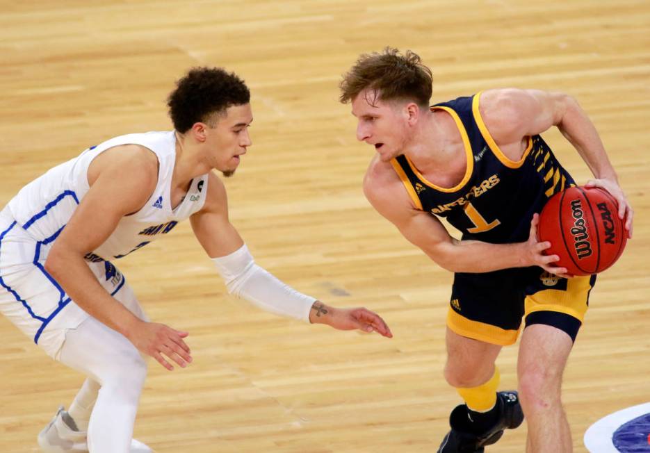 UC Irvine's Dawson Baker keeps the ball from UC Santa Barbara's JaQuori McLaughlin (3) during t ...