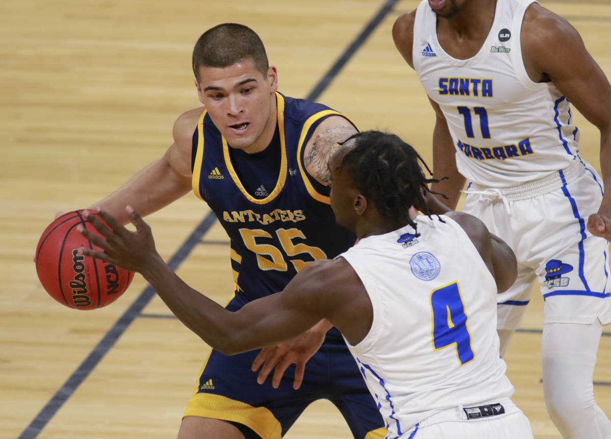 UC Irvine's Brad Greene (55) keeps the ball away from UC Santa Barbara's Devearl Ramsey (4) dur ...