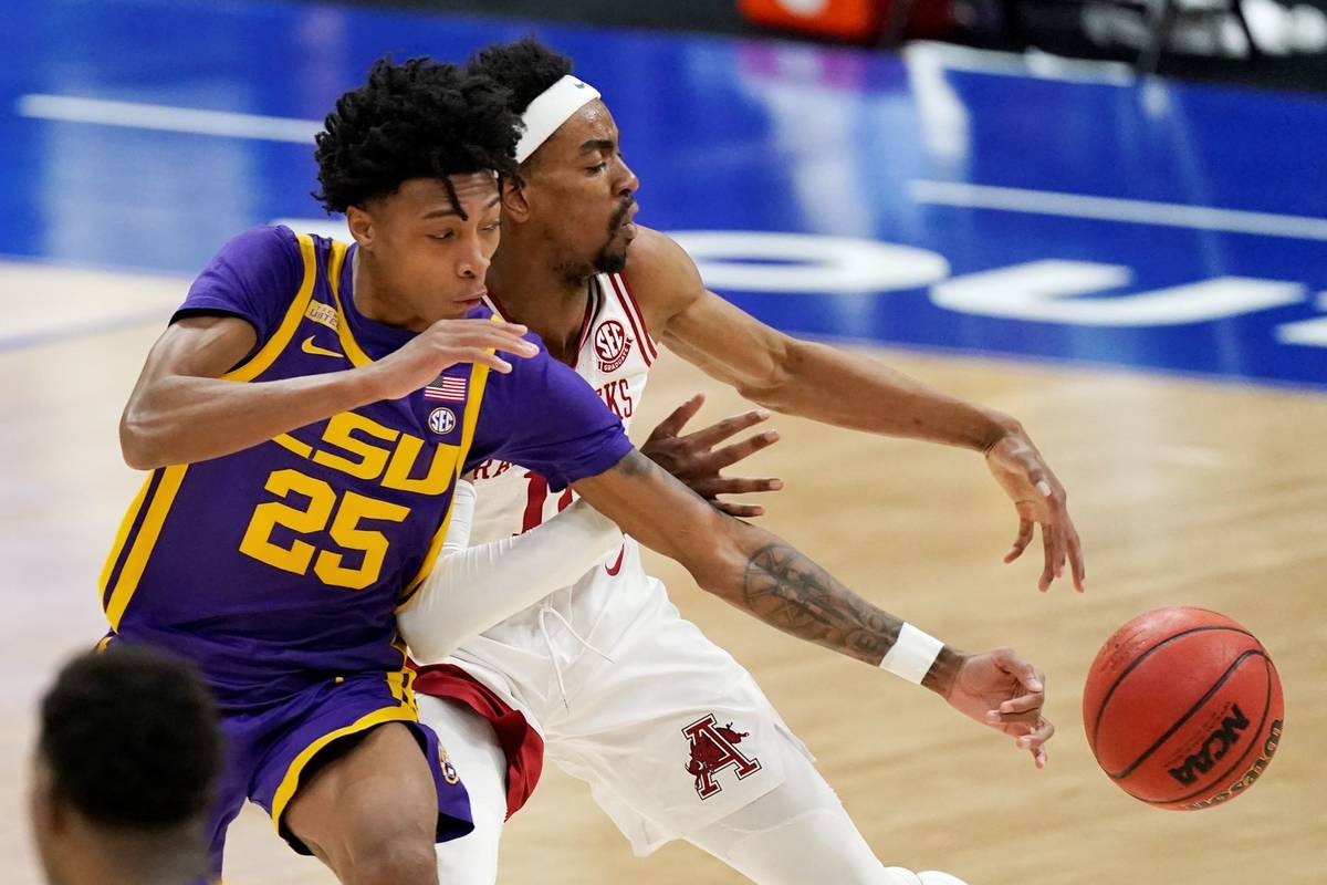 LSU's Eric Gaines (25) and Arkansas' Jalen Tate (11) reach for the ball in the second half of a ...